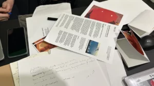 Close up of a messy desk with papers and books